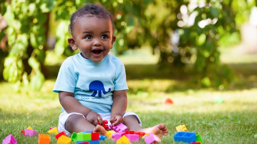 Baby playing with blocks in the grass Baby playing with blocks in the grass